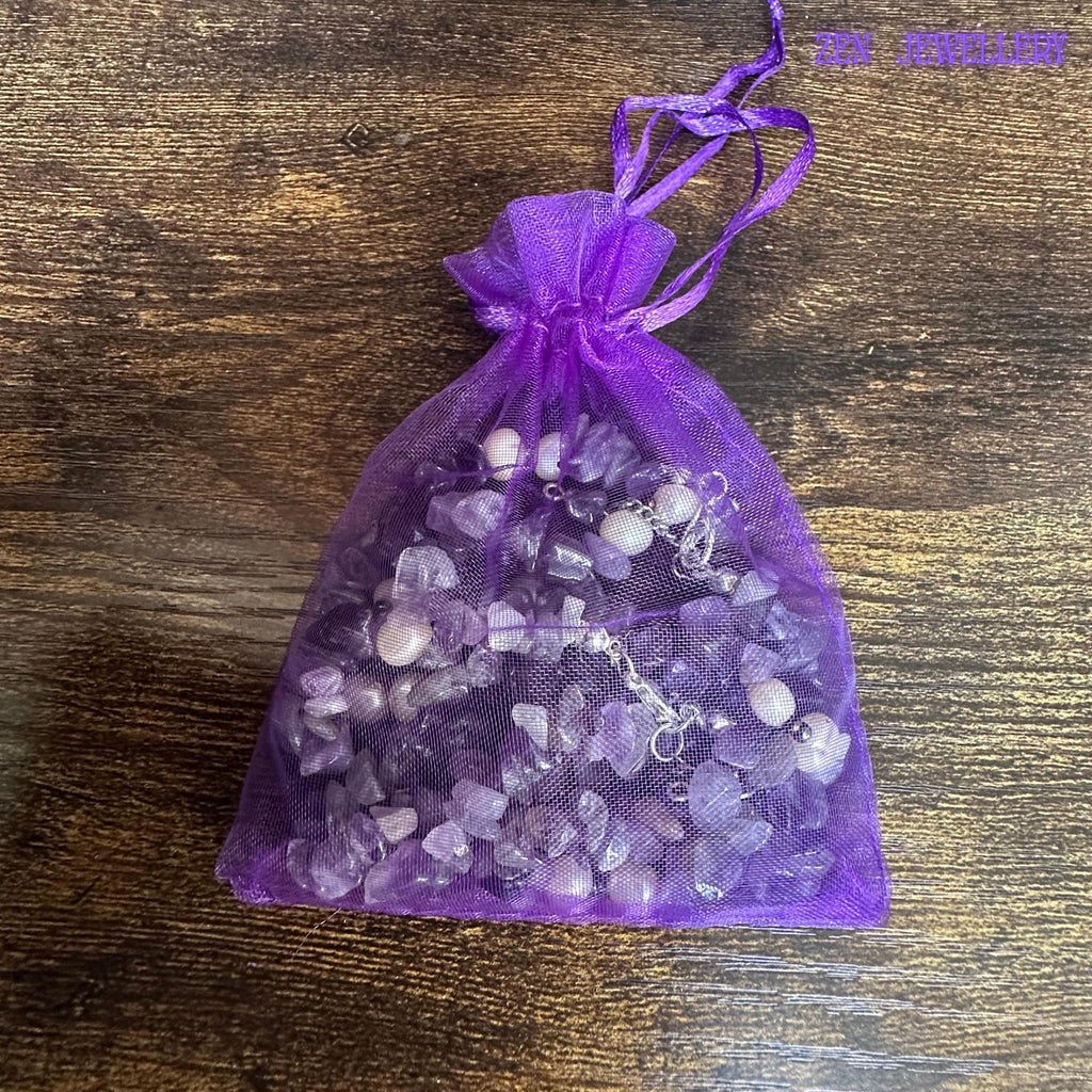 A close image focuses on the healing jewellery materials, showing the smooth stones and polished silver chain in a gift bag