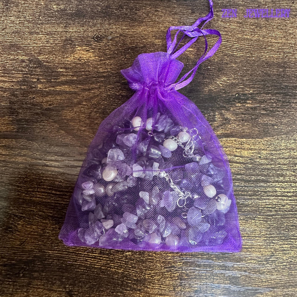 A close image focuses on the healing jewellery materials, showing the smooth stones and polished silver chain in a gift bag