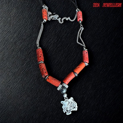 Handmade red coral jewellery necklace shown with natural cylindrical coral beads, black glossy beads, sparkling rhinestone spacers, and engraved silver tiger pendant. The mixed textures create an elegant yet edgy fashion accessory suitable for bohemian styling, statement outfits, or meaningful gifts. Necklace length approximately 22.8 inches.
