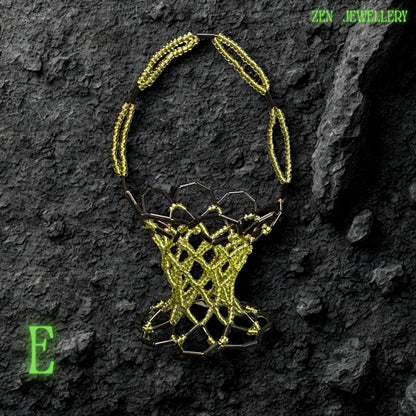 Side angle of a handmade green bead basket showing its curved structure and detailed craftsmanship