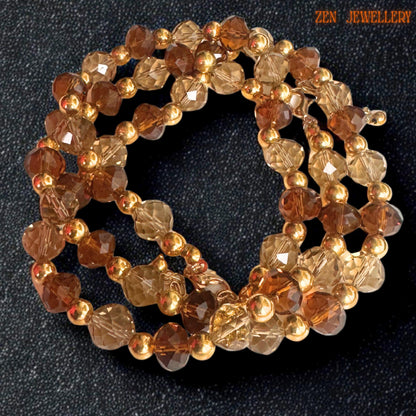 Handmade crystal jewellery set featuring warm champagne crystal beads alternating with rich brown faceted beads and glossy gold spacers creating a balanced elegant design. The luxurious sparkle and handcrafted arrangement make the jewellery perfect for sophisticated fashion lovers.