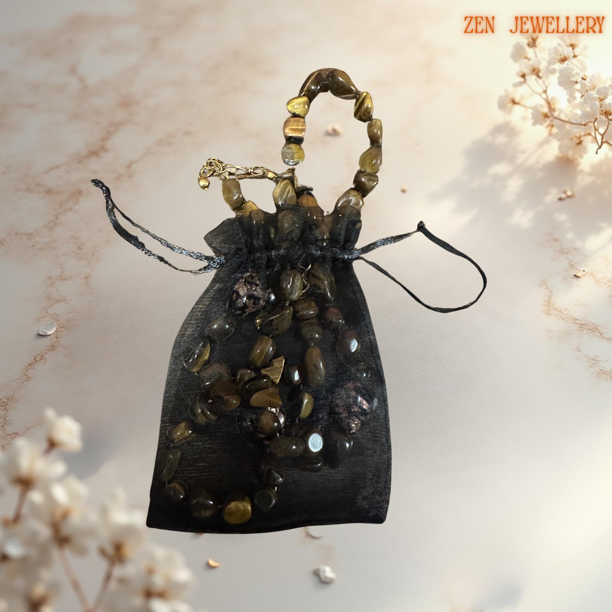 Elegant gemstone jewellery featuring tiger eye stones with silky lustre, paired with romantic heart-shaped glass in a pouch gift from the zen jewellery brand