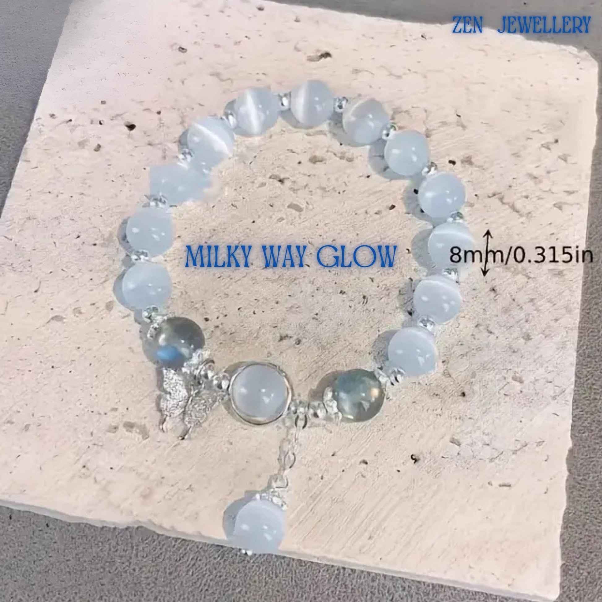 Detailed image focusing on the centrepiece featuring a bezel-set white gemstone charm framed by polished silver-toned metal, accompanied by a decorative butterfly charm symbolising beauty, transformation and freedom, while the surrounding gemstone arrangement enhances the bracelet's romantic appearance and luxurious handcrafted finish for jewellery lovers seeking distinctive accessories.