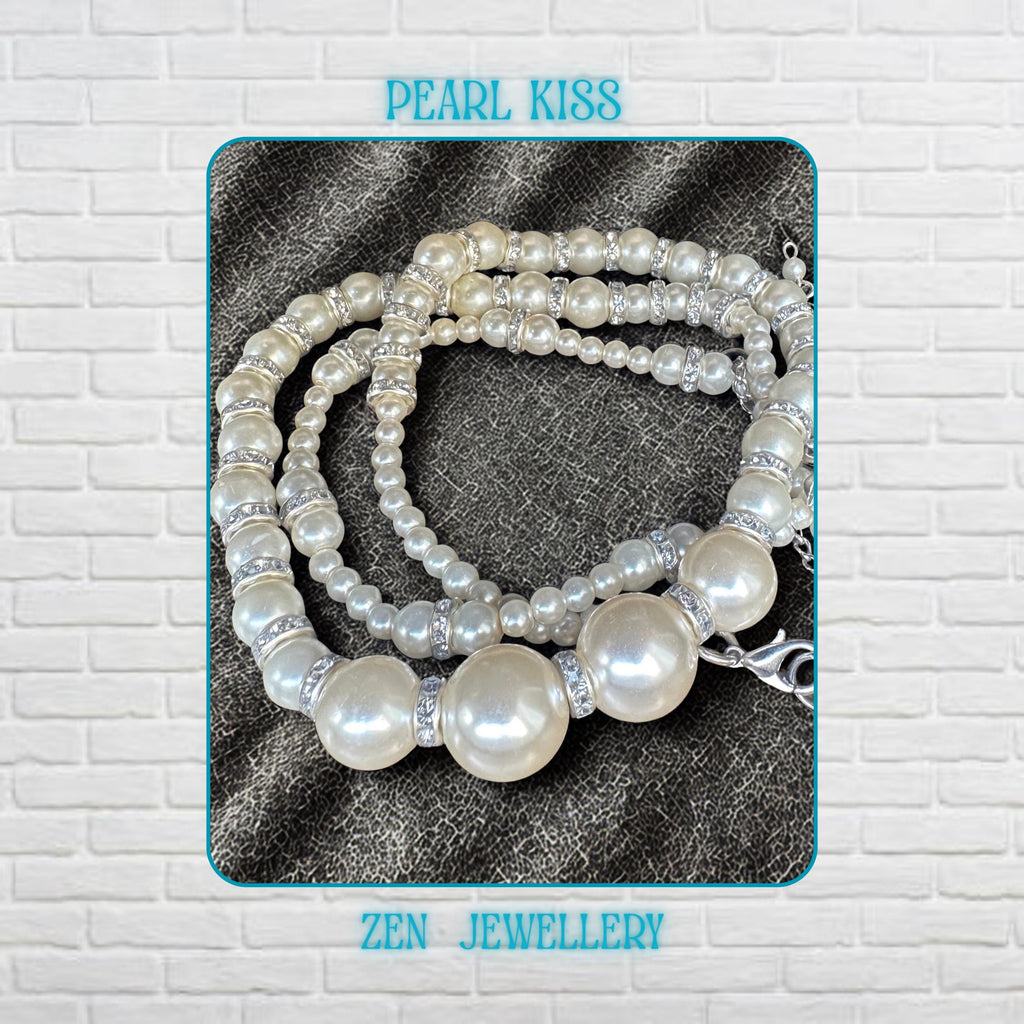 Feminine white pearl necklace and bracelet set featuring glossy cream pearl-style beads with sparkling silver rhinestone spacers creating a sophisticated handmade jewellery design. The necklace includes larger centre pearls surrounded by smaller round beads for texture and visual balance while the bracelet reflects the same timeless styling. The jewellery set creates a romantic lightweight and elegant appearance for bridal wear or special occasio