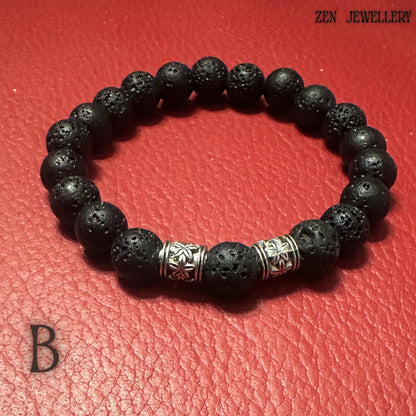 Detailed view of the handmade lava stone bracelet displaying different bead sizes and silver decorative spacer accents. The volcanic beads create a grounding, natural appearance while the silver details add brightness and elegance to the dark black tones. The bracelet creates a modern bohemian jewellery set perfect for casual outfits, spiritual styling, or meaningful gifting. The matte black texture gives the jewellery a timeless, minimalist aest
