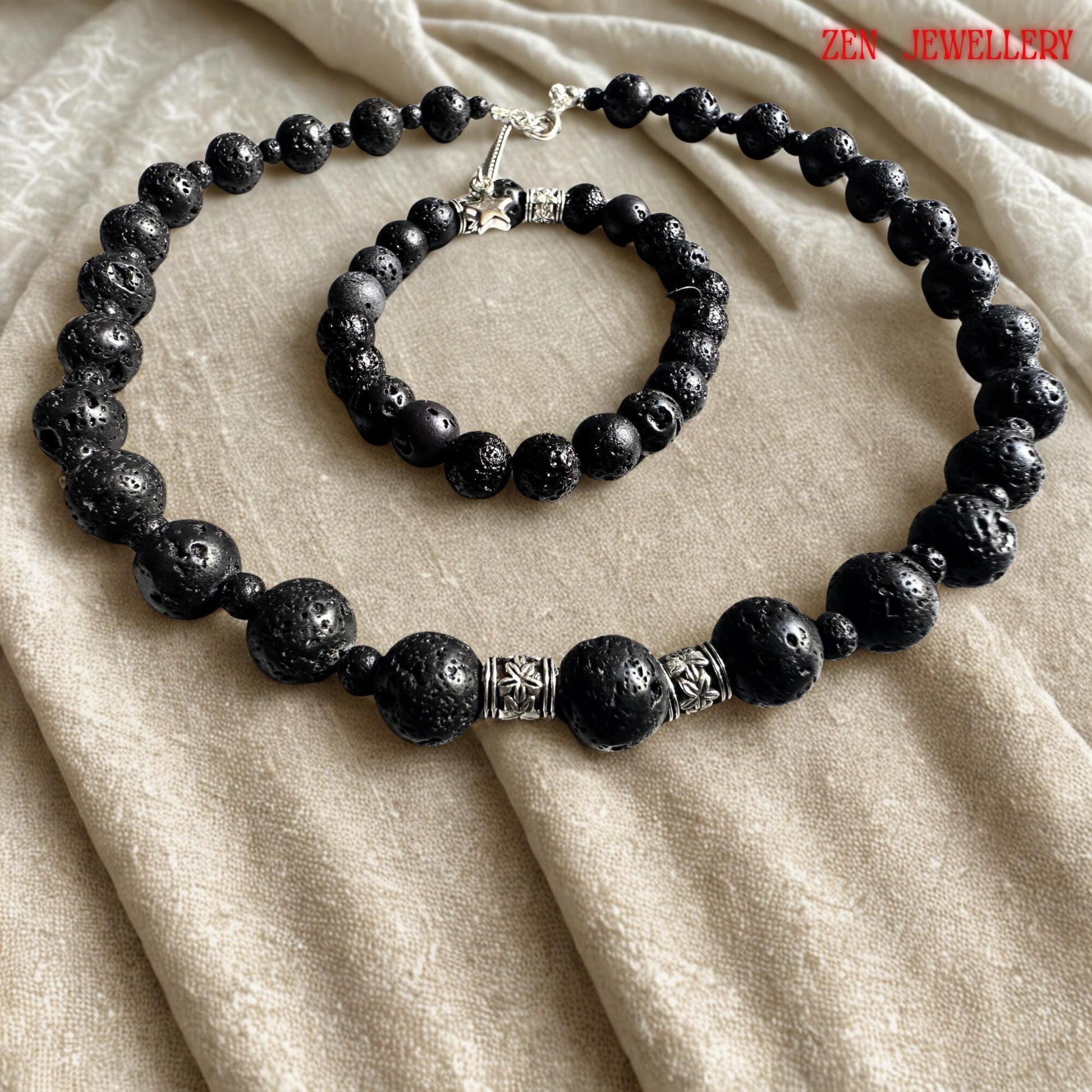 Handmade volcanic bead necklace featuring black lava stones arranged in a balanced graduated design with elegant silver spacer accents. The necklace includes a delicate silver extension chain and a small star charm that adds movement and detail to the earthy jewellery style. The porous matte stones reflect natural volcanic origins and create a calming, grounding aesthetic ideal for modern bohemian fashion lovers.