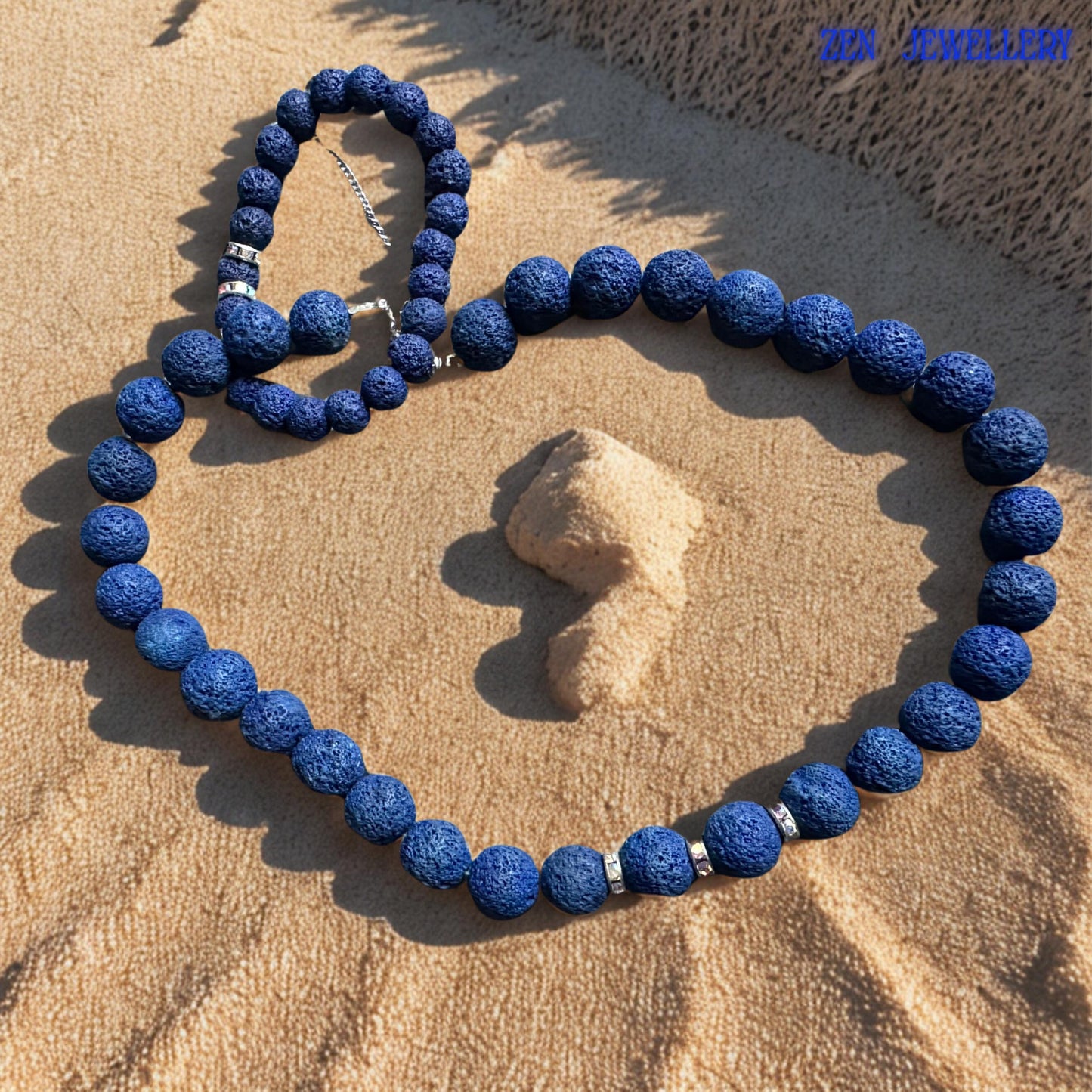 This handmade navy blue jewellery set combines natural lava stone texture with elegant rhinestone details for a timeless minimalist design. The matte volcanic beads create an earthy appearance inspired by natural stone formations, while the silver extension chain allows comfortable adjustable wear.