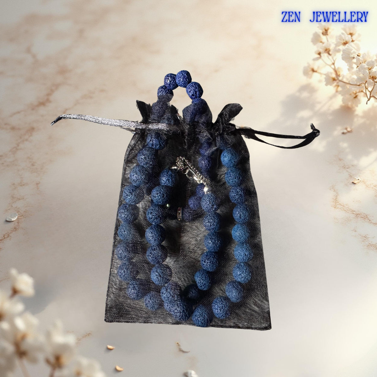 Natural navy lava stone beads paired with rhinestone spacers and delicate star pendant necklace in a gift bag