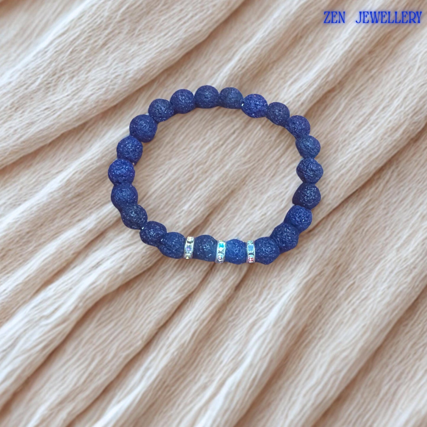 This elegant lava stone jewellery set is handcrafted using textured navy blue volcanic beads and silver rhinestone spacer accents. The natural matte finish of the lava stones creates strong earthy character, while the sparkling details add contrast and feminine elegance to the handmade design.