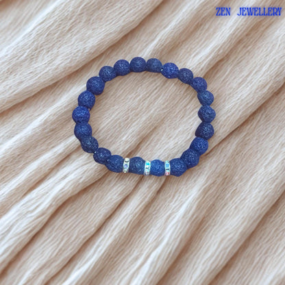 This elegant lava stone jewellery set is handcrafted using textured navy blue volcanic beads and silver rhinestone spacer accents. The natural matte finish of the lava stones creates strong earthy character, while the sparkling details add contrast and feminine elegance to the handmade design.