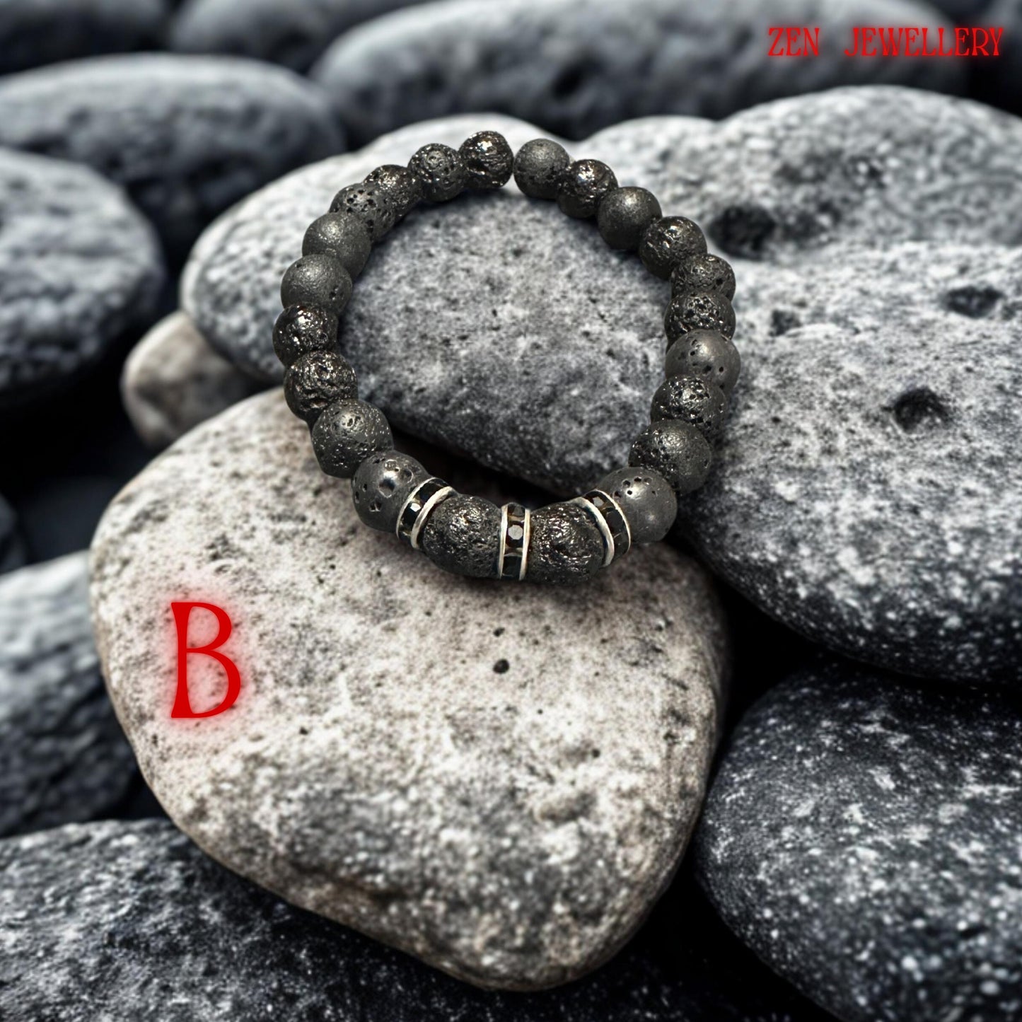 Minimalist black lava bracelet styled on a natural stone background, highlighting the porous volcanic texture and handmade craftsmanship. The bracelet combines matte black beads with sparkling black rhinestone spacers creating modern boho jewellery suitable for casual outfits or layered styling.