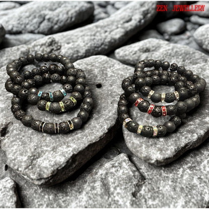 Elegant handmade bracelets featuring black lava stones and silver rhinestone spacers for women. Natural lava stone bracelets with mixed volcanic bead sizes arranged symmetrically around bright red, black, green, turquoise crystal spacer rings. The bracelets has grounding earthy texture with subtle sparkle details and modern handmade design. The dark matte beads create elegant contrast against the vivid rhinestone accents.