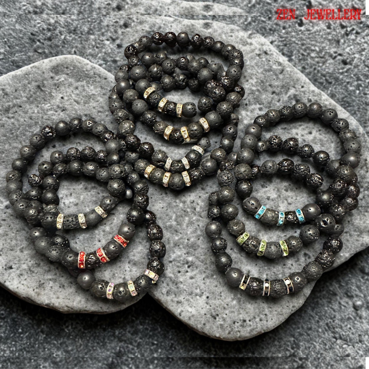Healing energy bracelet made of lava stones with red, blue, and green rhinestones, elastic and stylish. Elegant handmade bracelets featuring black lava stones and silver rhinestone spacers for women. Natural lava stone bracelets with mixed volcanic bead sizes arranged symmetrically around bright red, black, green, turquoise crystal spacer rings. The bracelets has grounding earthy texture with subtle sparkle details and modern handmade design.
