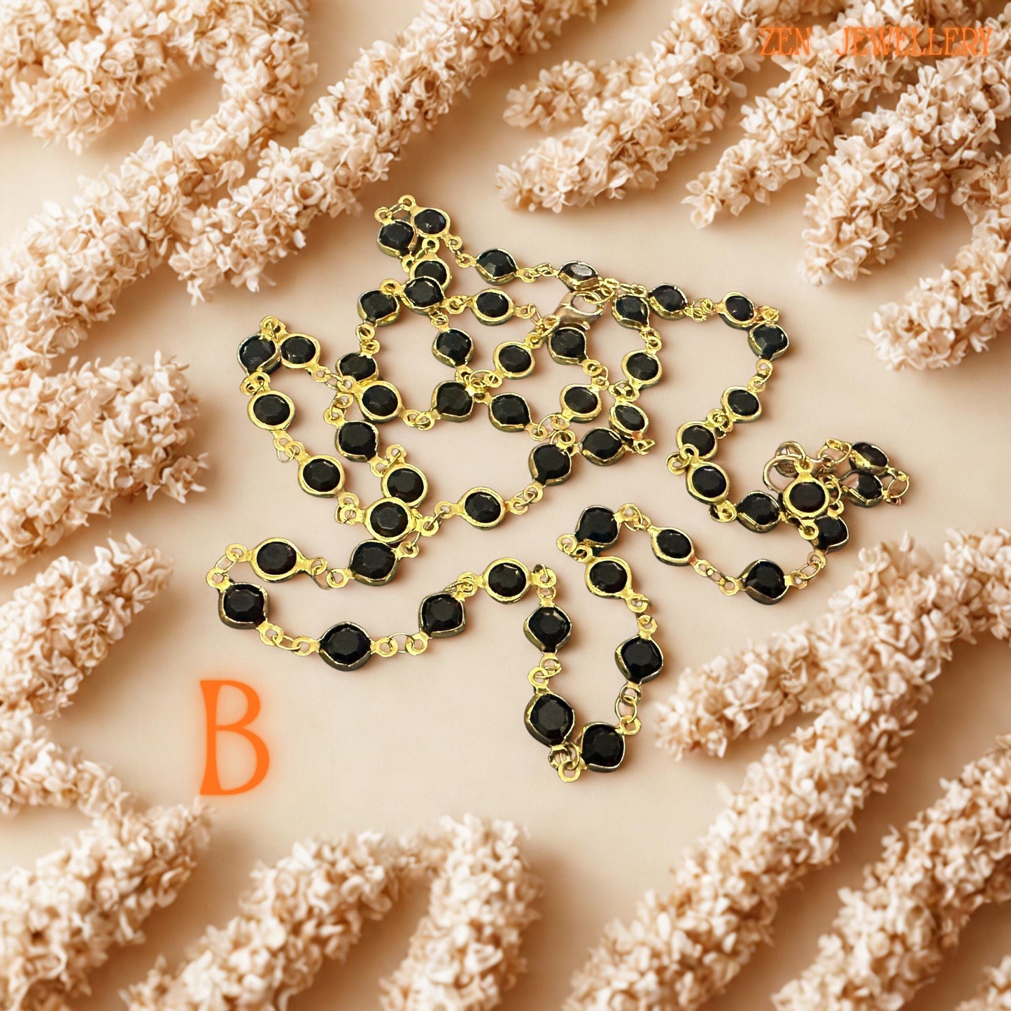 Artistic close-up image of the black crystal bracelet highlights glossy faceted stones framed in polished gold settings. The contrast between deep black gemstones and warm metallic chain creates minimalist luxury with modern elegance. Each crystal reflects subtle light while the handcrafted gold links add fluidity and graceful movement, making the jewellery versatile for elegant evening wear or sophisticated everyday styling.
