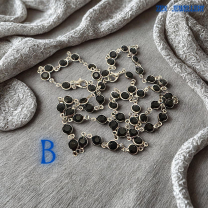 This handmade black crystal jewellery set displays evenly spaced faceted black crystal stones securely connected by delicate silver-tone chain links. The reflective crystal surfaces create subtle sparkle while maintaining an elegant monochromatic look. Lightweight construction ensures comfortable wear throughout the day, making this Crystal Silver necklace and bracelet set ideal for modern women seeking timeless accessories, statement jewellery,