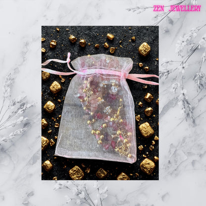Handmade gemstone bracelet featuring pink and transparent beads, sparkling rhinestones, and golden accents.