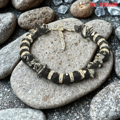 Detailed close-up of the silver clasp and extension chain. The polished silver components provide secure fastening while allowing adjustable sizing for greater comfort. The quality hardware complements the black and grey colour palette while adding durability and functionality to the bracelet.