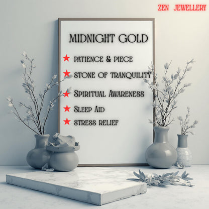A framed print with the words "MIDNIGHT GOLD" and benefits like "Patience & Piece" and "Stress Relief." The print is displayed with decorative vases and branches. The text "ZEN JEWELLERY" is in the top right corner.