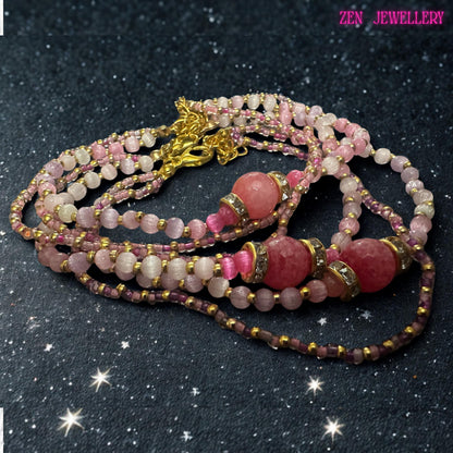 This image showcases the elegant balance between delicate beadwork and statement design. Rose crystal beads in pale pink shades contrast beautifully with the richer raspberry coloured centre bead. Silver tone rhinestone spacers add sparkle from multiple angles, while the gold toned hardware complements the warm colour scheme. The bracelet wraps comfortably around the wrist and can be adjusted using the included extender chain.
