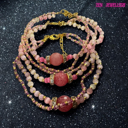 The bracelet is photographed while worn on the wrist, helping demonstrate scale and how the multiple strands drape naturally against the skin. Soft pink crystal beads create a feminine colour palette while gold spacer beads add warmth and contrast. A large raspberry pink bead forms the focal point and is surrounded by rhinestone accents for additional sparkle. Measurement information and sizing guidance are included within the product description