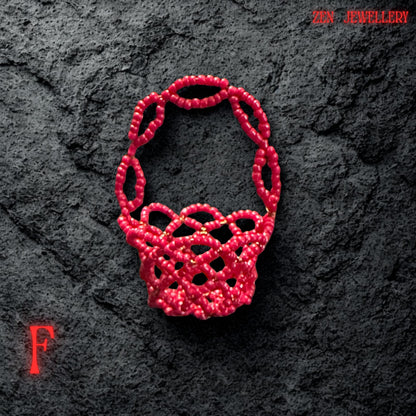 A side view highlights the curved walls of the basket formed from sparkling red Miyuki seed beads.