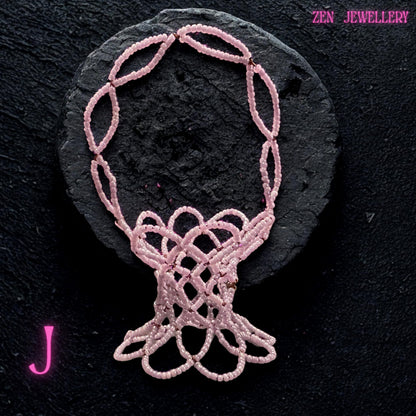 Close detail of the glossy pink Miyuki beads woven into a sturdy decorative bowl.