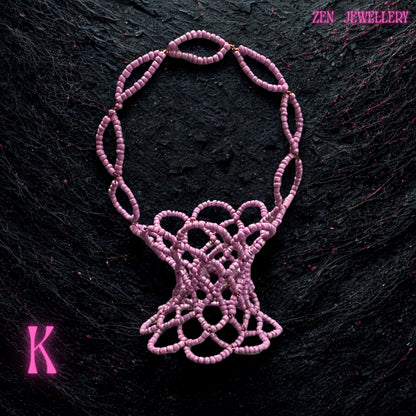 Small pink beadwork basket photographed on a clean background to highlight its colour and craftsmanship.