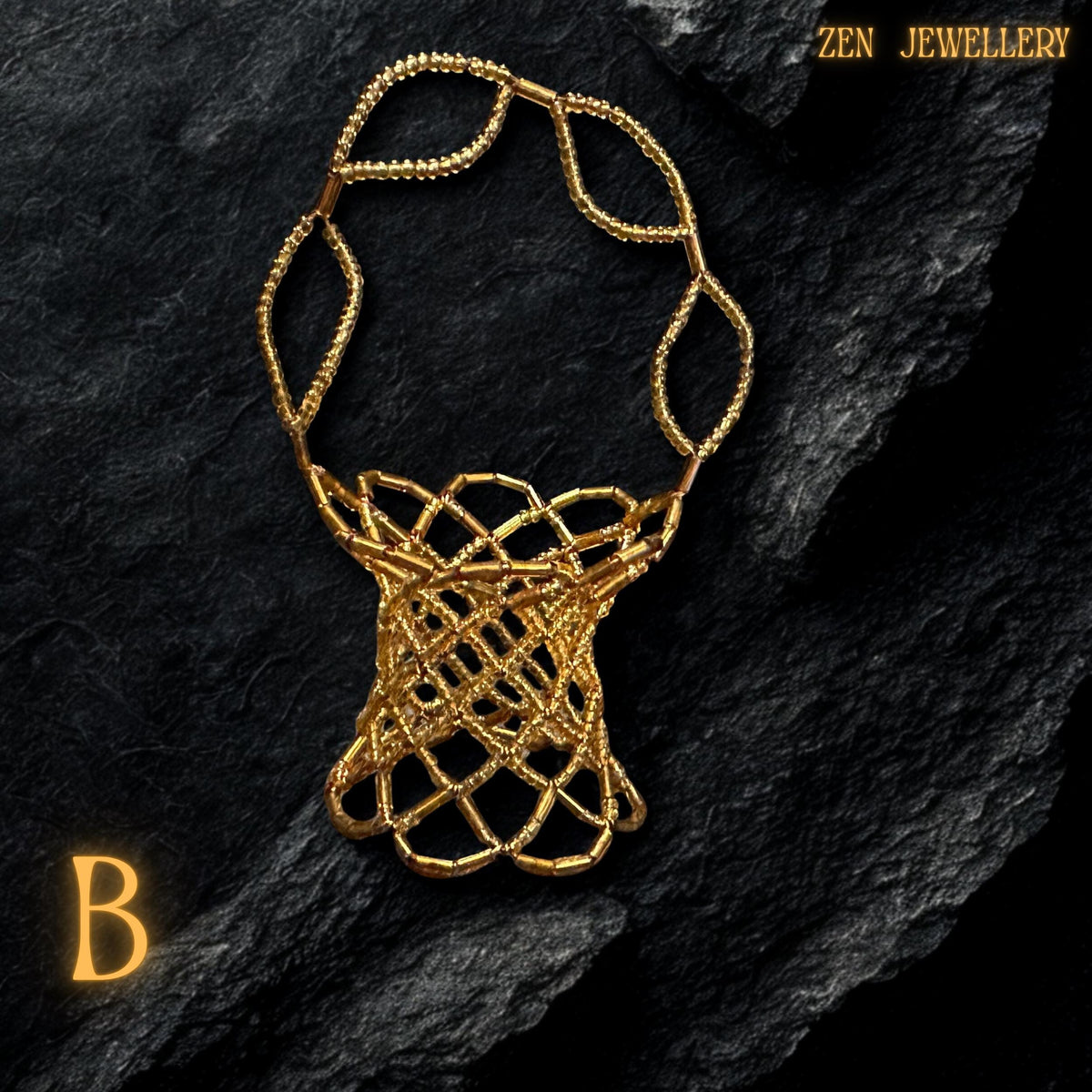 A gold beadwork basket placed on a black rock surface to showcase its artisanal craftsmanship.