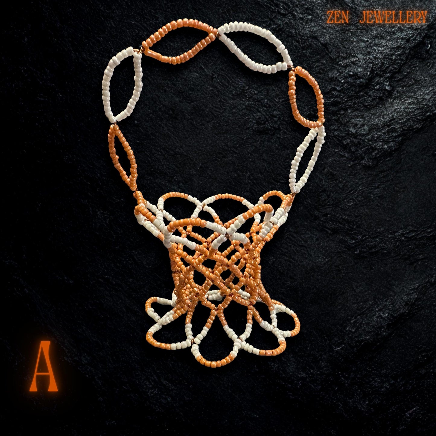Close-up showing the vibrant orange and bright white Miyuki beads forming a glossy beaded mini bowl.