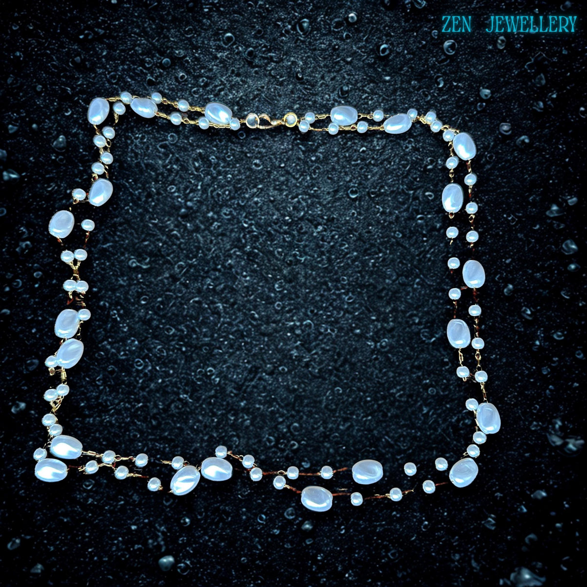 The handmade layered necklace is designed with glossy white oval beads and tiny round beads attached to fine gold chain details. The flowing shape creates texture and elegant movement while the soft pearl-inspired colours give the piece a feminine and calming look. The necklace feels lightweight and comfortable for everyday wear.