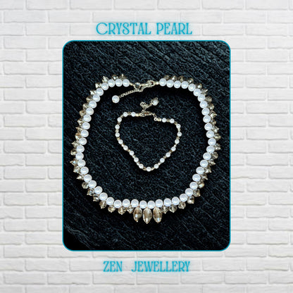 Close-up view of a handmade white pearl jewellery set with sparkling grey crystal accents and silver rhinestone spacer details arranged on a dark textured surface. The necklace features alternating glossy pearl-style beads and faceted crystal beads creating elegant texture and contrast. The matching bracelet includes delicate silver chain details and a secure clasp closure. This lightweight bridal-inspired jewellery set creates a romantic and lux