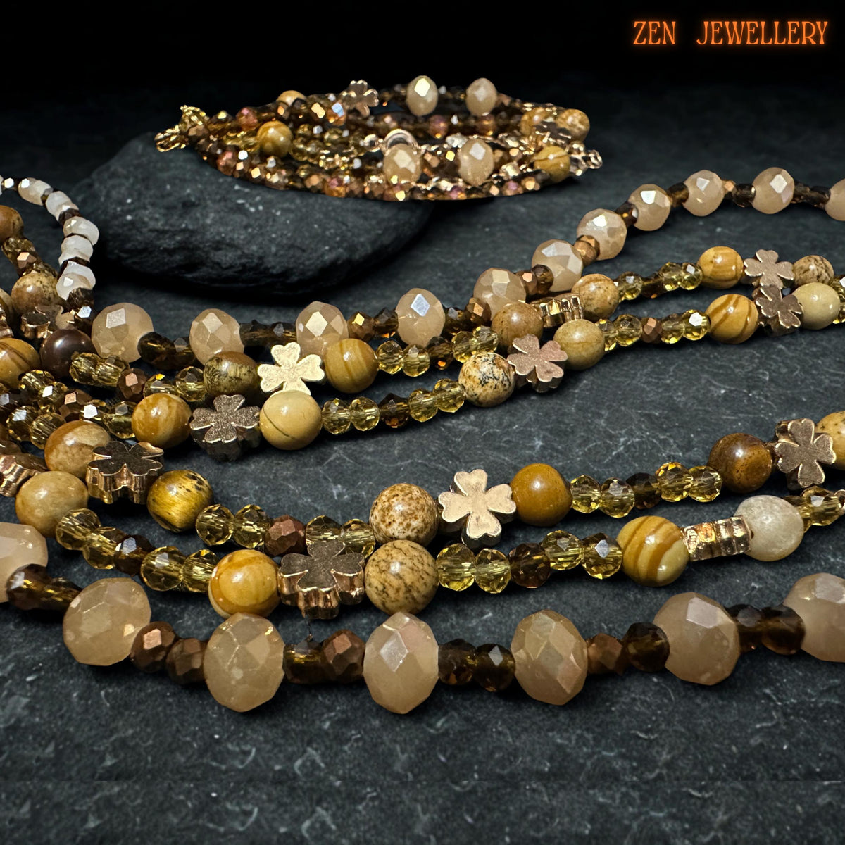Detailed view of the gold-plated chain extender and clasps on the triple-strand necklace.