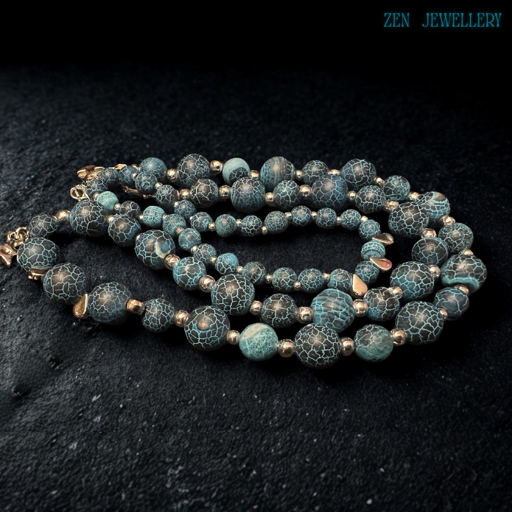 Handmade Blue Crackle Agate necklace displayed from an angled perspective highlighting the balanced arrangement of graduated turquoise gemstone beads, silver spacer accents, polished silver chain extension, and dangling star charms while emphasizing the artistic handcrafted structure, celestial bohemian styling, and comfortable wearable design suitable for modern fashion lovers.