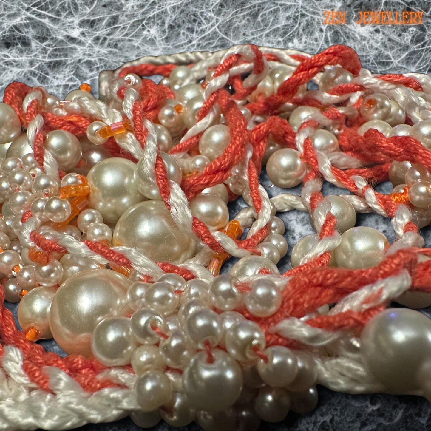 • Romantic WHITE PEARL tassel necklace featuring cascading pearl strands woven carefully into coral and cream crochet cords for an elegant handmade appearance. The layered asymmetrical design creates luxurious movement and artistic texture while maintaining lightweight comfort. The mixed pearl sizes reflect soft light beautifully and contrast gently with the warm coral thread tones. This expressive bohemian jewellery piece feels feminine, luxurio