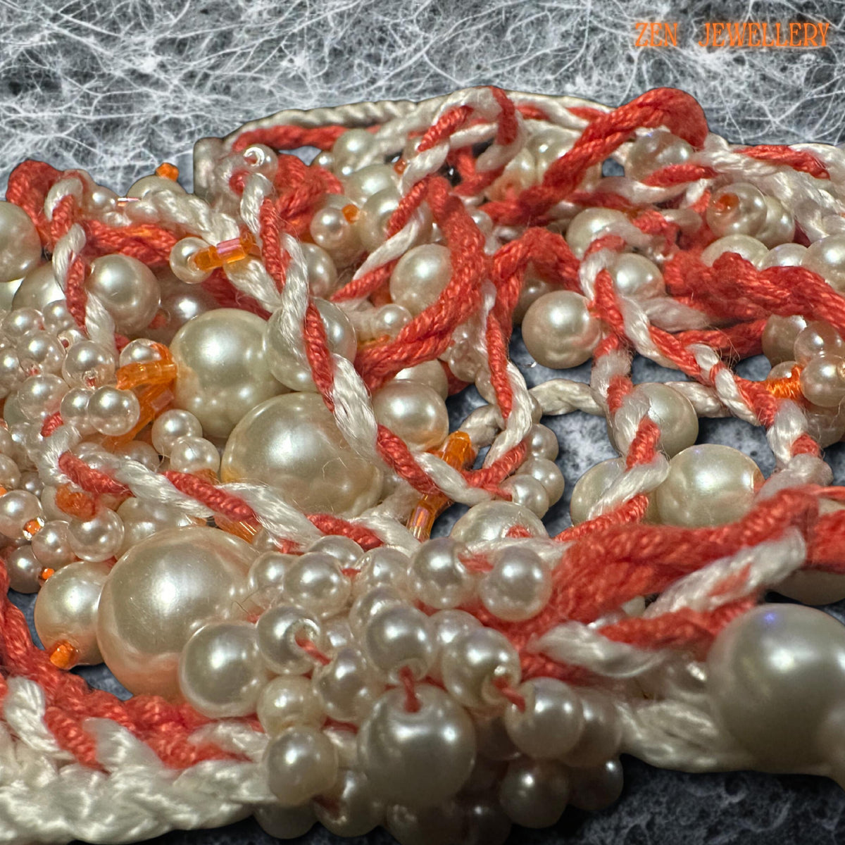 • Romantic WHITE PEARL tassel necklace featuring cascading pearl strands woven carefully into coral and cream crochet cords for an elegant handmade appearance. The layered asymmetrical design creates luxurious movement and artistic texture while maintaining lightweight comfort. The mixed pearl sizes reflect soft light beautifully and contrast gently with the warm coral thread tones. This expressive bohemian jewellery piece feels feminine, luxurio