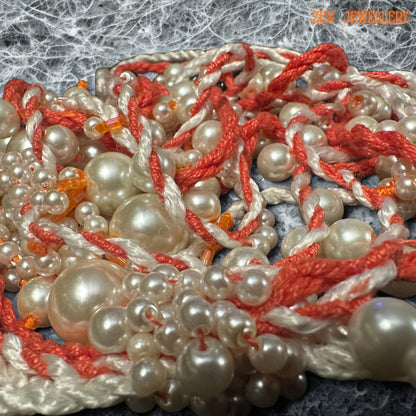 • Romantic WHITE PEARL tassel necklace featuring cascading pearl strands woven carefully into coral and cream crochet cords for an elegant handmade appearance. The layered asymmetrical design creates luxurious movement and artistic texture while maintaining lightweight comfort. The mixed pearl sizes reflect soft light beautifully and contrast gently with the warm coral thread tones. This expressive bohemian jewellery piece feels feminine, luxurio