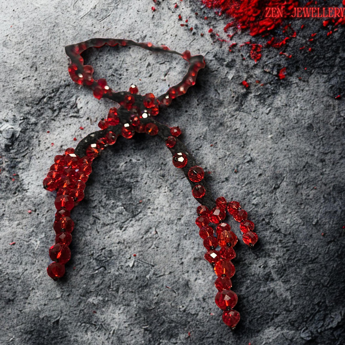 Detailed overhead photograph of the RED CRYSTAL crochet necklace highlighting the sparkling faceted bead surfaces and soft textile texture. The necklace combines sculptural braided black strands with shimmering ruby crystals that appear suspended organically along flowing lines. The asymmetrical handcrafted layout creates modern artistic movement and dramatic luxury styling. The elegant shape makes the piece ideal for gothic fashion, evening wear