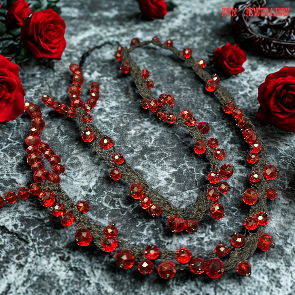 Romantic handmade RED CRYSTAL necklace featuring deep crimson faceted beads attached onto flowing black crochet cords with careful craftsmanship. The irregular crystal arrangement creates sculptural texture and natural movement while reflecting light beautifully from different angles. The soft braided strands contrast elegantly with the intense ruby sparkle and create a luxurious couture-inspired style. The necklace feels expressive, feminine, ar