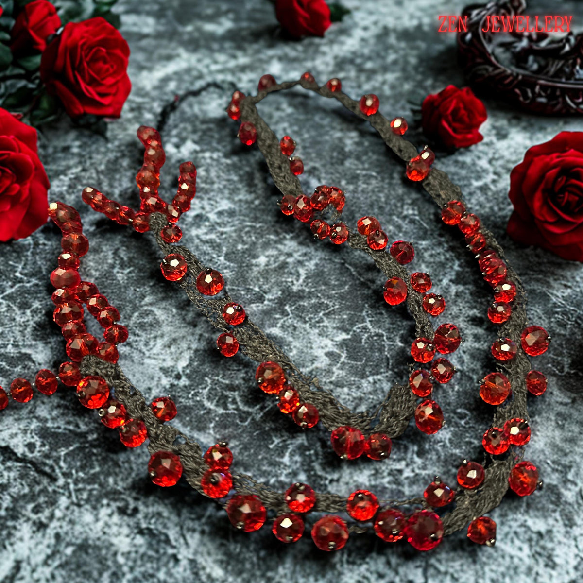 Romantic handmade RED CRYSTAL necklace featuring deep crimson faceted beads attached onto flowing black crochet cords with careful craftsmanship. The irregular crystal arrangement creates sculptural texture and natural movement while reflecting light beautifully from different angles. The soft braided strands contrast elegantly with the intense ruby sparkle and create a luxurious couture-inspired style. The necklace feels expressive, feminine, ar