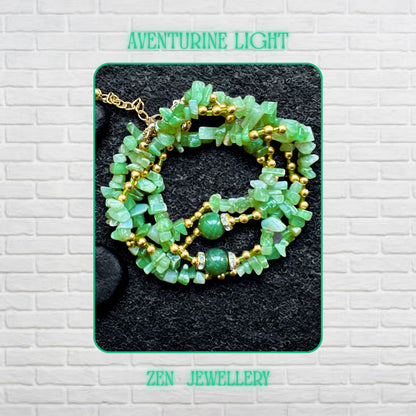 Boho green gemstone jewellery set with irregular aventurine crystal chips and warm golden beads styled in an artistic layered necklace arrangement. Green jade necklace with sparkling rhinestone details and gold clasp photographed closely to show the glossy gemstone finish and handcrafted design. Handmade festival jewellery set featuring earthy green crystal chips, elegant gold spacer beads, and soft natural gemstone colour variations.