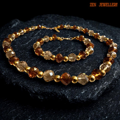 Handmade crystal jewellery set featuring alternating caramel and champagne AUSTRIAN CRYSTAL beads separated by glossy gold spacer beads and finished with elegant gold clasp closures. The rich amber tones create warmth and depth while the faceted bead texture adds beautiful sparkle and graceful movement.