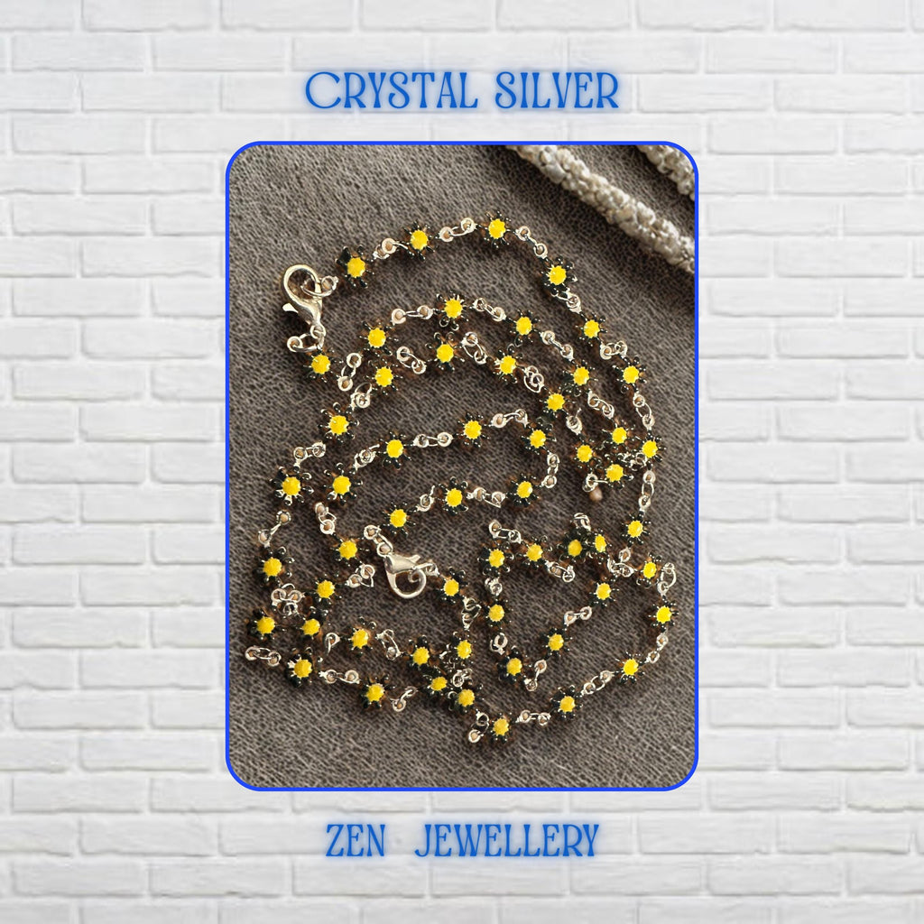 Detailed view of the Crystal Silver floral jewellery set showcasing numerous miniature yellow flower crystals connected by delicate silver links. Each flower-shaped crystal creates sparkle and texture while contributing to the overall botanical theme. The necklace and bracelet feel lightweight and feminine, making them perfect accessories for nature-inspired outfits, summer occasions, floral fashion collections, and cheerful everyday styling.