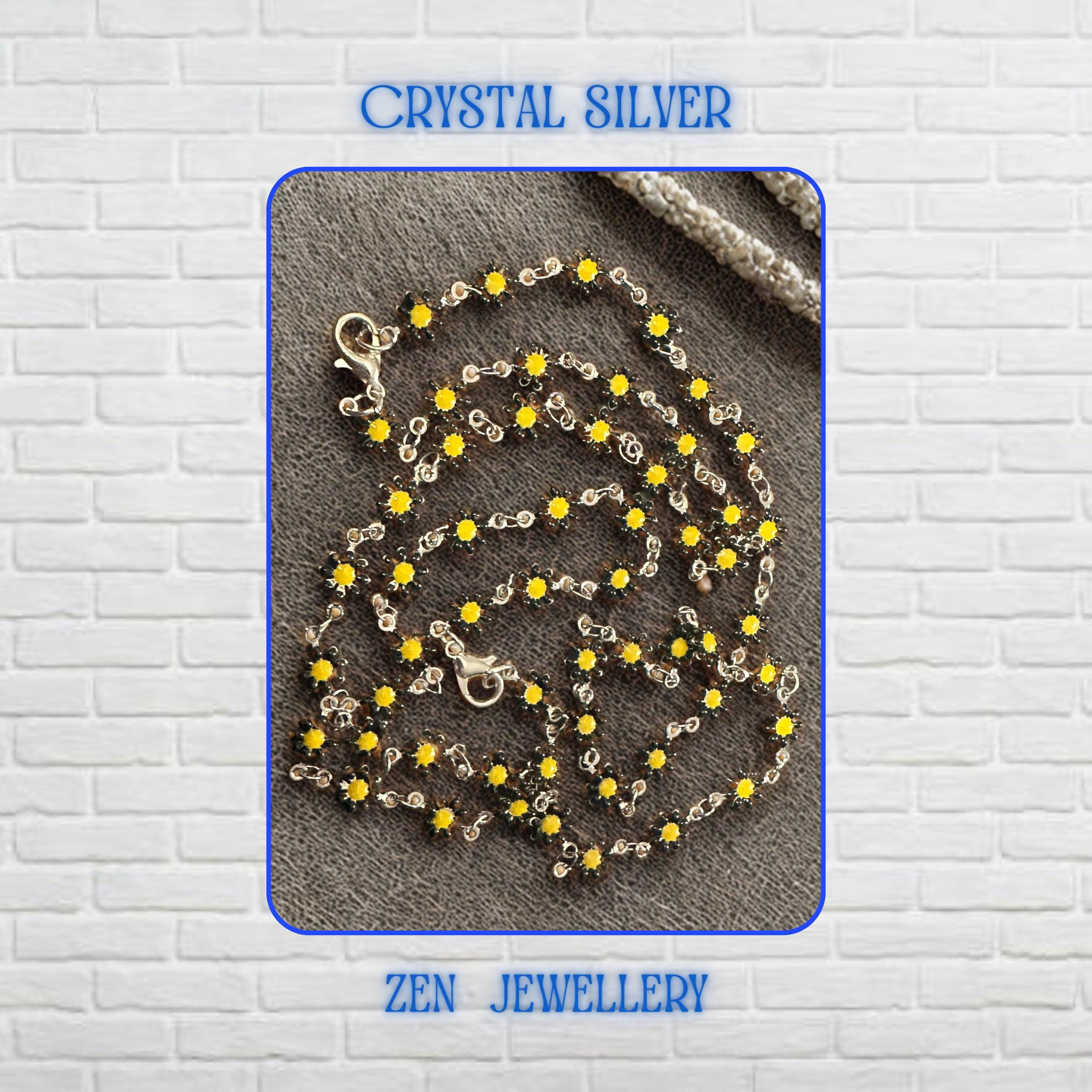 Detailed view of the Crystal Silver floral jewellery set showcasing numerous miniature yellow flower crystals connected by delicate silver links. Each flower-shaped crystal creates sparkle and texture while contributing to the overall botanical theme. The necklace and bracelet feel lightweight and feminine, making them perfect accessories for nature-inspired outfits, summer occasions, floral fashion collections, and cheerful everyday styling.