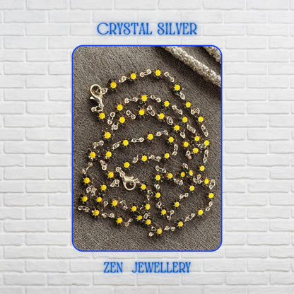Detailed view of the Crystal Silver floral jewellery set showcasing numerous miniature yellow flower crystals connected by delicate silver links. Each flower-shaped crystal creates sparkle and texture while contributing to the overall botanical theme. The necklace and bracelet feel lightweight and feminine, making them perfect accessories for nature-inspired outfits, summer occasions, floral fashion collections, and cheerful everyday styling.