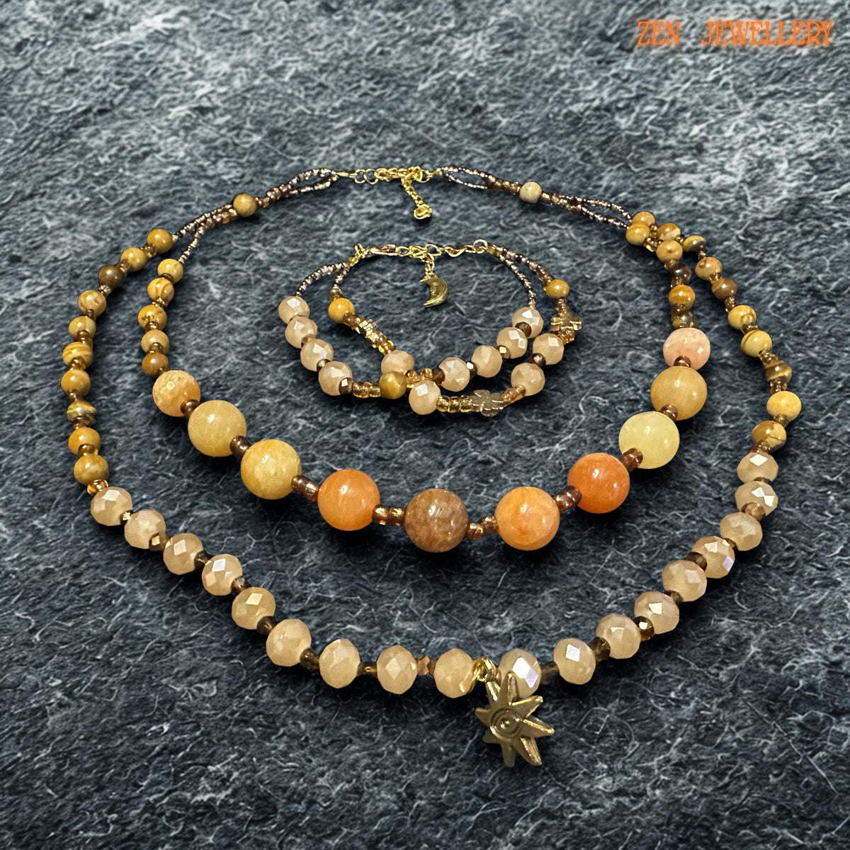 Elegant handmade jewellery piece featuring yellow jade, honey jade, and champagne crystal beads. The natural-looking gemstone tones create a calming earthy style, while the gold accents add luxury and warmth.
The necklace includes two layered strands with different bead sizes for added interest and movement. The bracelet repeats the same colour palette and handcrafted feel for a complete jewellery set.