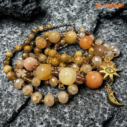 Elegant boho jewellery set with warm honey and caramel beads paired with sparkling champagne crystal details. The design feels lightweight, artisanal, and easy to style with neutral or earthy outfits.
The layered strands create graceful movement and a soft luxurious look. The matching bracelet mirrors the necklace beautifully, making this a complete handmade gemstone jewellery set.