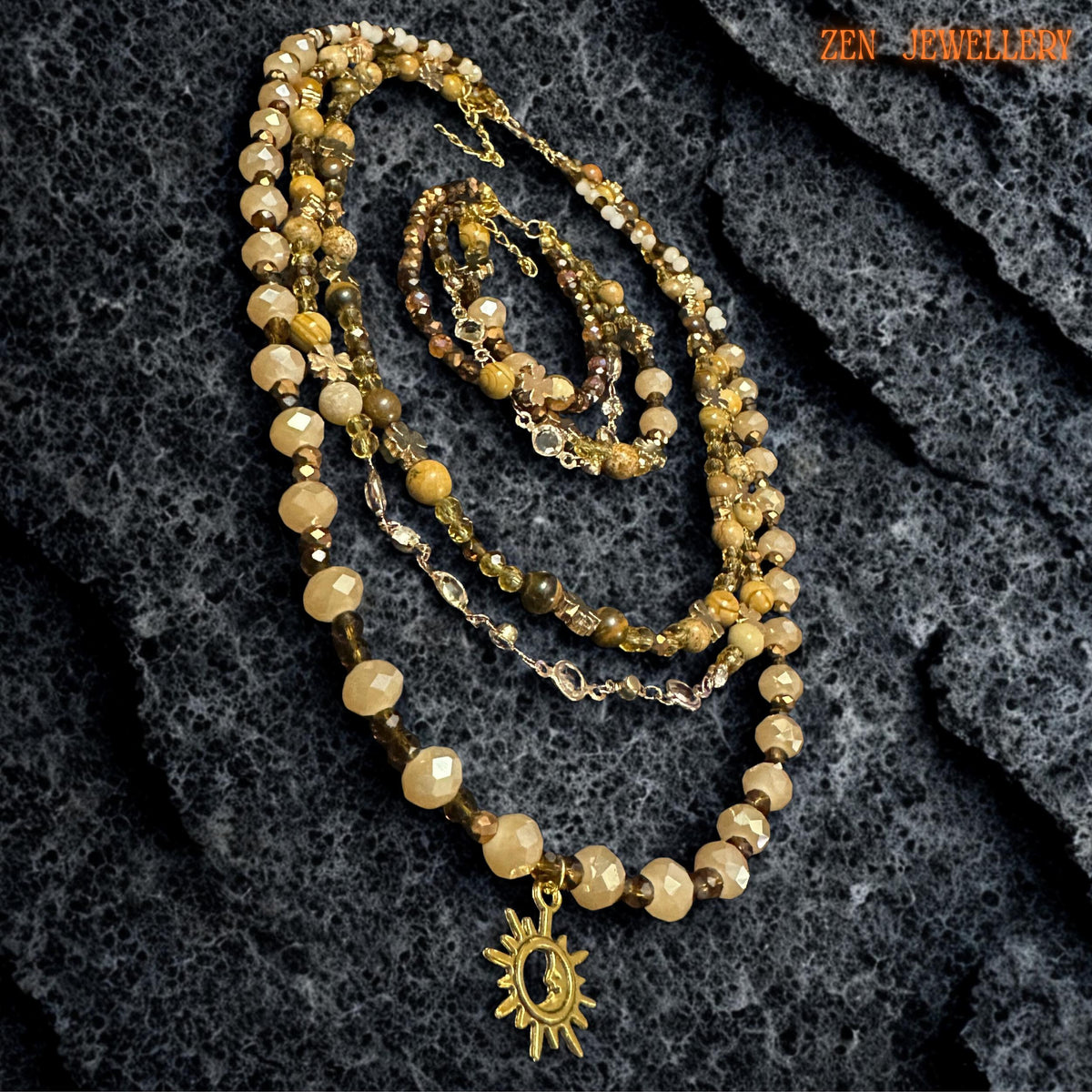 Triple-strand bracelet with faceted crystals and gold accents arranged beside the matching layered necklace.