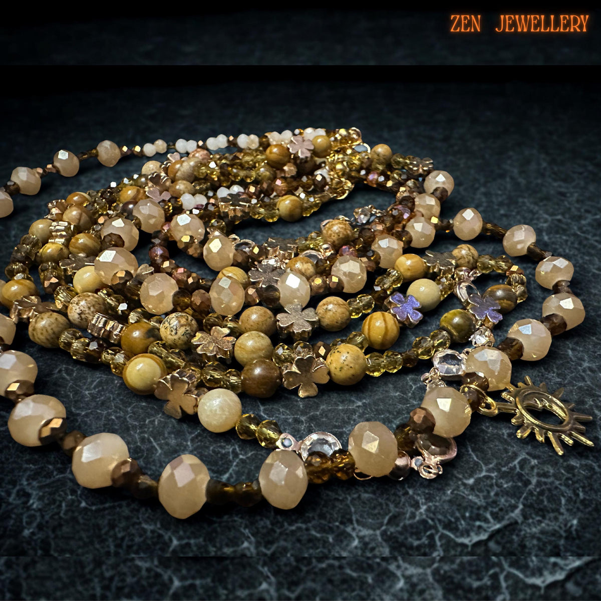 Earth-tone gemstone beads and gold charms forming a layered boho jewellery set for women.