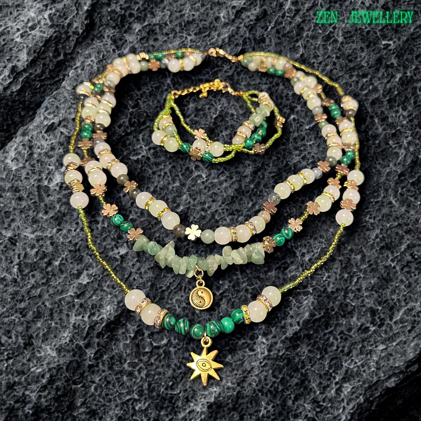 • Artistic layered crystal necklace featuring soft green aventurine beads, ivory gemstone accents, shimmering metallic seed beads, and sparkling rhinestone spacers combined with celestial jewellery charms. The elegant handcrafted design includes a gold sun pendant and yin yang charm that add mystical spiritual symbolism and romantic bohemian elegance to the overall gemstone jewellery composition.