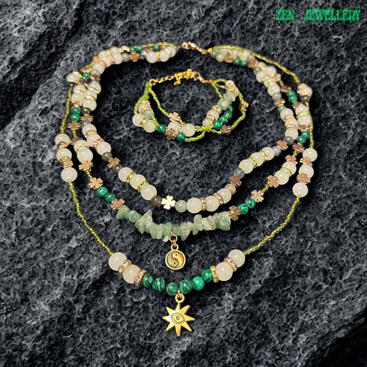 • Artistic layered crystal necklace featuring soft green aventurine beads, ivory gemstone accents, shimmering metallic seed beads, and sparkling rhinestone spacers combined with celestial jewellery charms. The elegant handcrafted design includes a gold sun pendant and yin yang charm that add mystical spiritual symbolism and romantic bohemian elegance to the overall gemstone jewellery composition.